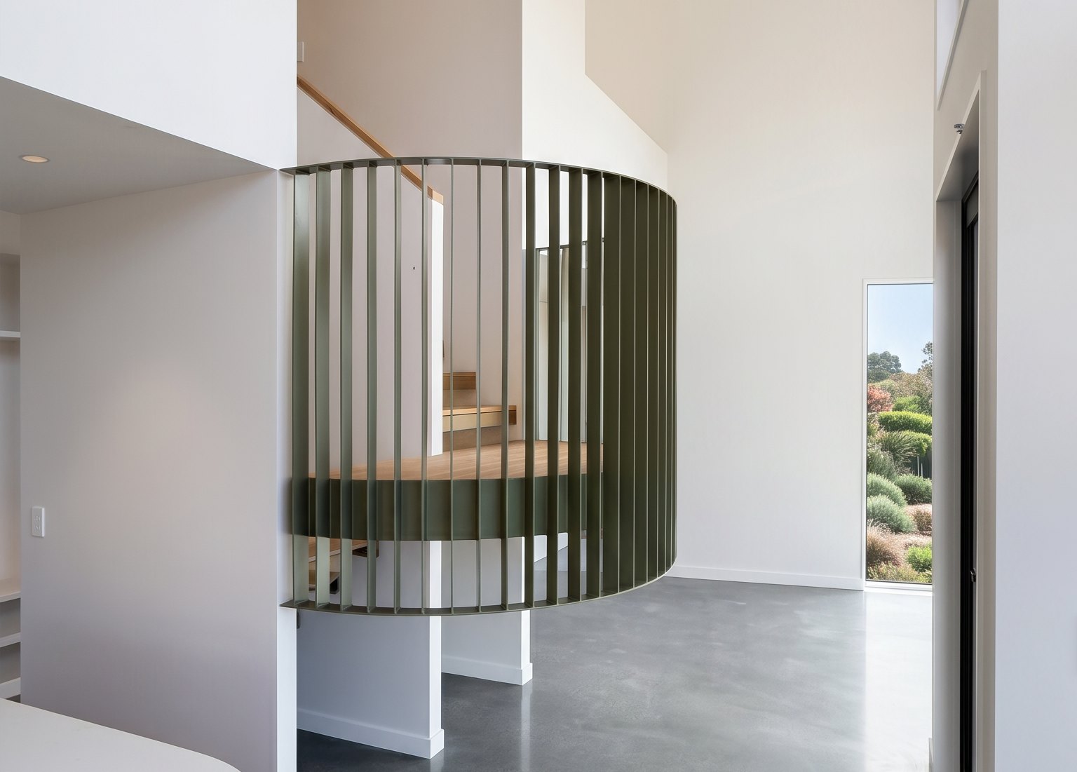 Floating circular staircase with solid oak treads inside a surround of olive-green flat-bar steel, in a home at Mt Pleasant, Christchurch
