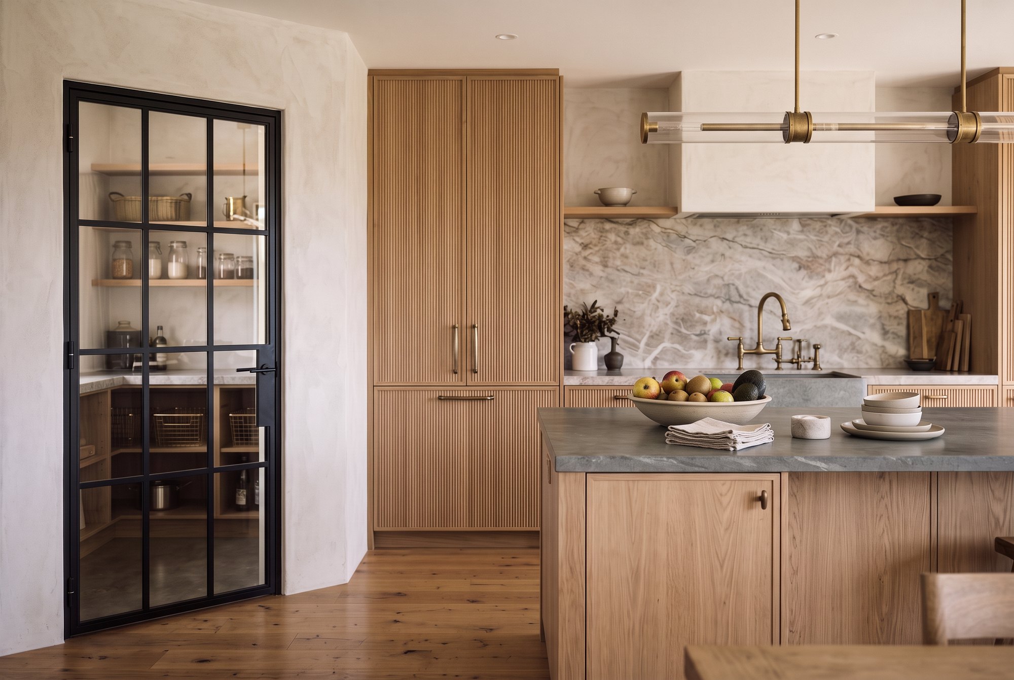 Single black steel Crittall-style door to a scullery in a modern oak and stone kitchen